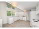 Bright kitchen featuring white appliances, cabinets, and countertops with linoleum flooring at 2027 Jefferson Dr, Hillsborough, NC 27278