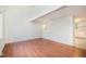 Bright living room with hardwood floors and a partial view of the kitchen at 2027 Jefferson Dr, Hillsborough, NC 27278