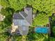 Stunning aerial view of home with solar panels, a backyard pool, and mature trees at 204 Rossburn Way, Chapel Hill, NC 27516
