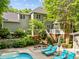 Lush backyard oasis with a sparkling pool, manicured landscaping, and a cozy patio area at 204 Rossburn Way, Chapel Hill, NC 27516