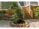 Charming backyard pond, landscaping, and stairway to upper patio at 204 Rossburn Way, Chapel Hill, NC 27516