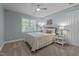 Comfortable bedroom with light blue paint, ceiling fan, and cozy decor at 204 Rossburn Way, Chapel Hill, NC 27516