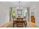 Elegant dining room featuring a wood table, chandelier, and large windows, perfect for gatherings at 204 Rossburn Way, Chapel Hill, NC 27516
