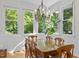 Bright dining room with a wooden table, chandelier, and large windows at 204 Rossburn Way, Chapel Hill, NC 27516
