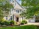 Charming front exterior with landscaped yard, an American flag, and a two-car garage at 204 Rossburn Way, Chapel Hill, NC 27516