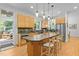 Kitchen featuring an island with bar seating, stainless steel appliances, and wooden cabinetry at 204 Rossburn Way, Chapel Hill, NC 27516