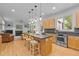Open kitchen with a large center island, pendant lighting, and stainless steel appliances at 204 Rossburn Way, Chapel Hill, NC 27516