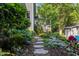 Lush landscaping surrounds this home, enhancing the natural beauty of the property at 204 Rossburn Way, Chapel Hill, NC 27516