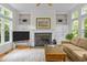 Living room featuring a fireplace, built-in shelving, and large windows at 204 Rossburn Way, Chapel Hill, NC 27516