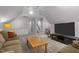 Cozy living room featuring plush seating, a ceiling fan, and a convenient wet bar area at 204 Rossburn Way, Chapel Hill, NC 27516