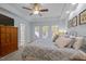 Light-filled main bedroom featuring a tray ceiling and an attached ensuite bathroom at 204 Rossburn Way, Chapel Hill, NC 27516