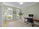 Bright office space with ample natural light, neutral walls, and classic hardwood floors, ideal for productivity at 204 Rossburn Way, Chapel Hill, NC 27516