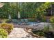 Beautiful pool area features multiple lounge chairs and lush landscaping for outdoor enjoyment at 204 Rossburn Way, Chapel Hill, NC 27516