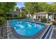 A luxurious pool and cabana invite you to experience outdoor living at its finest at 204 Rossburn Way, Chapel Hill, NC 27516