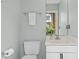 This powder room features a pedestal sink, toilet, and framed mirror at 204 Rossburn Way, Chapel Hill, NC 27516