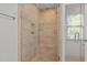 Beautifully tiled shower with glass door and built-in seat at 204 Rossburn Way, Chapel Hill, NC 27516