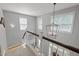 Bright staircase with natural light, modern lighting fixture, and neutral colors at 204 Rossburn Way, Chapel Hill, NC 27516