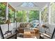 Cozy sunroom with ample natural light and comfortable seating overlooking the backyard at 204 Rossburn Way, Chapel Hill, NC 27516