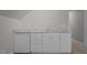 Wet bar featuring granite countertops, white cabinets, and a built-in mini fridge at 204 Rossburn Way, Chapel Hill, NC 27516