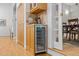 A wine cooler is next to wooden storage cabinets at 204 Rossburn Way, Chapel Hill, NC 27516