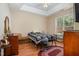 Cozy bedroom featuring wood floors, tray ceiling, and natural light from the window at 209 Mccarthy Dr, Clayton, NC 27527