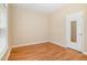 A bright empty bedroom with hardwood floors, neutral walls, and a closet at 209 Mccarthy Dr, Clayton, NC 27527