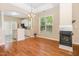Dining room area with view of kitchen featuring hardwood floors, a fireplace, and ample natural light at 209 Mccarthy Dr, Clayton, NC 27527