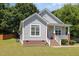 Charming home with a covered front porch and well-maintained landscaping at 209 Mccarthy Dr, Clayton, NC 27527