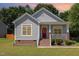 Charming single-Gathering home with a red front door, a cozy front porch and professionally landscaped yard at 209 Mccarthy Dr, Clayton, NC 27527