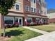 A multi-story mixed-use building featuring well-maintained landscaping, brick accents and pedestrian-friendly access at 209 Mccarthy Dr, Clayton, NC 27527