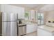 Bright kitchen featuring stainless steel appliances, white cabinetry, and tile flooring at 209 Mccarthy Dr, Clayton, NC 27527