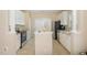 Galley kitchen with stainless steel appliances, white cabinets, and an island, offering ample counter space at 209 Mccarthy Dr, Clayton, NC 27527