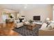 Inviting living room with hardwood floors, fireplace, and large windows for ample natural light, leading into dining area at 209 Mccarthy Dr, Clayton, NC 27527