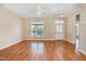 Bright living room featuring hardwood floors, a ceiling fan, and a large window allowing for ample natural light at 209 Mccarthy Dr, Clayton, NC 27527