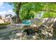 Beautiful backyard with water feature, Adirondack chairs, and a lush green landscape at 2210 Bedford Ave, Raleigh, NC 27607
