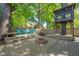 Landscaped backyard featuring fire pit, outdoor seating, and a charming treehouse at 2210 Bedford Ave, Raleigh, NC 27607