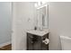 Bathroom featuring a black vanity with marble countertop, white walls, and chrome fixtures at 2210 Bedford Ave, Raleigh, NC 27607