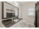 Cozy bathroom featuring a dark granite counter, mirror, and black-and-white tiled floors at 2210 Bedford Ave, Raleigh, NC 27607