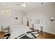 Bedroom featuring hardwood floors, neutral walls, white bedding, and a decorative chandelier at 2210 Bedford Ave, Raleigh, NC 27607