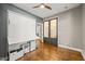 Flex room with hardwood floors, a stylish wall bed, and french doors at 2210 Bedford Ave, Raleigh, NC 27607