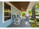 Inviting front porch with rocking chairs, offering a relaxing space to enjoy the neighborhood views at 2210 Bedford Ave, Raleigh, NC 27607
