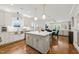 Modern kitchen with island, white cabinets, stainless appliances, and open to the living area at 2210 Bedford Ave, Raleigh, NC 27607