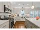 Modern kitchen with stainless steel appliances, white cabinets, hardwood floors, and a large island at 2210 Bedford Ave, Raleigh, NC 27607