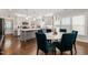 Modern kitchen with island, white cabinets, stainless appliances, and dining area at 2210 Bedford Ave, Raleigh, NC 27607