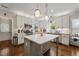 Modern kitchen with island, stainless steel appliances, and white cabinets at 2210 Bedford Ave, Raleigh, NC 27607