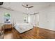 Main bedroom with wood floors, a ceiling fan, and a barn door leading to the bathroom at 2210 Bedford Ave, Raleigh, NC 27607
