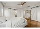 Spacious main bedroom featuring hardwood floors, barn doors, a large mirror and white walls at 2210 Bedford Ave, Raleigh, NC 27607