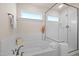 Bright bathroom with soaking tub, glass shower enclosure, and tile surround at 232 Kanewind Ter, Apex, NC 27523