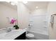 This bathroom features a single sink vanity, and tub and shower combo with a decorative flower at 232 Kanewind Ter, Apex, NC 27523