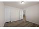 This bedroom features neutral walls, light-colored wood-look floors, and ample closet space at 232 Kanewind Ter, Apex, NC 27523